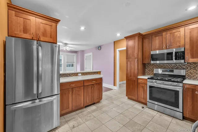a kitchen with stainless steel appliances granite countertop a refrigerator stove and sink