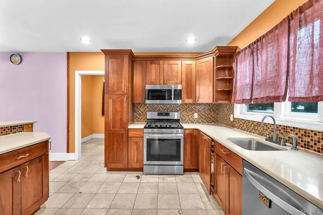 a kitchen with a stove a sink and a microwave