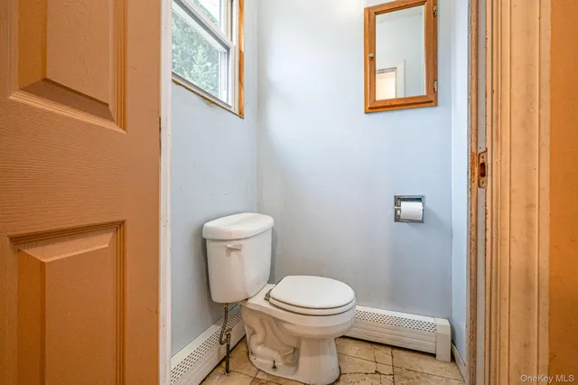 a white toilet sitting next to a shower curtain