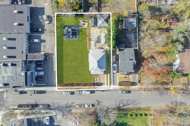 an aerial view of residential house with outdoor space and parking