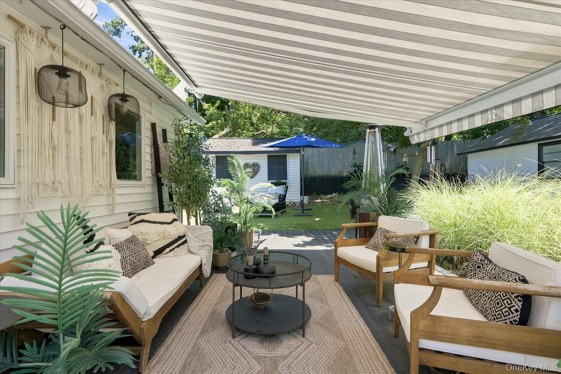 88 Cherry Road Rocky Point, NY 11778 - Photo 6 of 32 Retractable awning makes your deck like a private courtyard in all seasons and all types of weather
