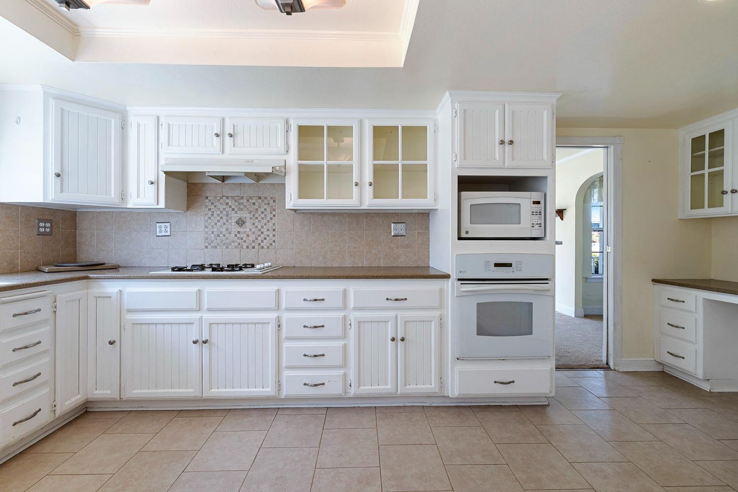 695 Monroe Street Coalinga, CA 93210 - Photo 12 of 44 a kitchen with cabinets appliances and a window