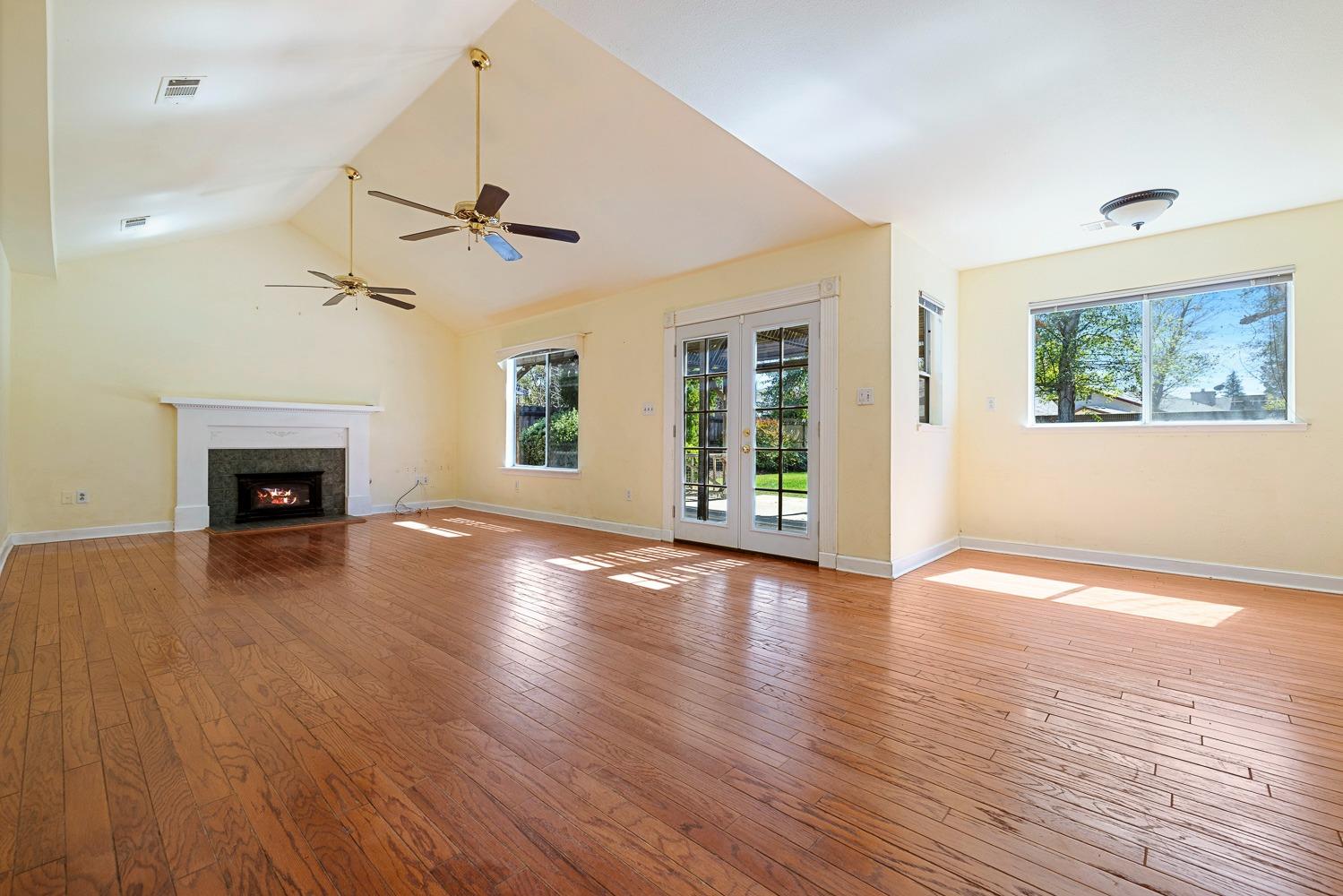 695 Monroe Street Coalinga, CA 93210 - Photo 17 of 44 a view of an empty room with wooden floor fireplace and a window