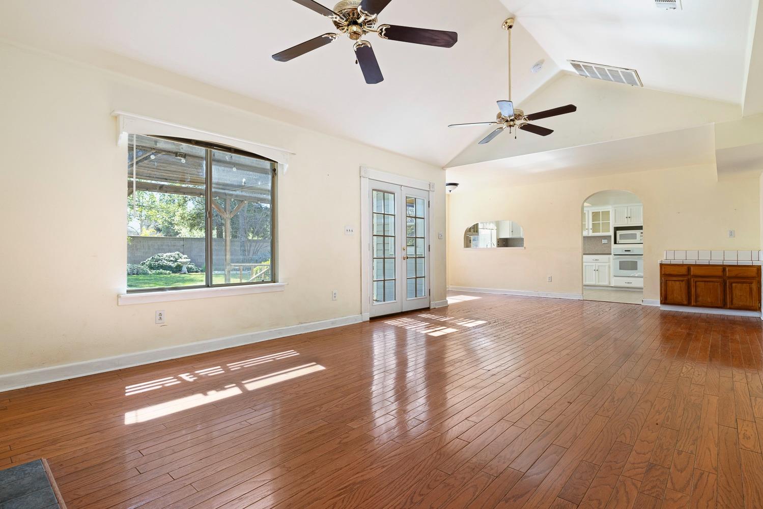 695 Monroe Street Coalinga, CA 93210 - Photo 19 of 44 a view of empty room with wooden floor and fan