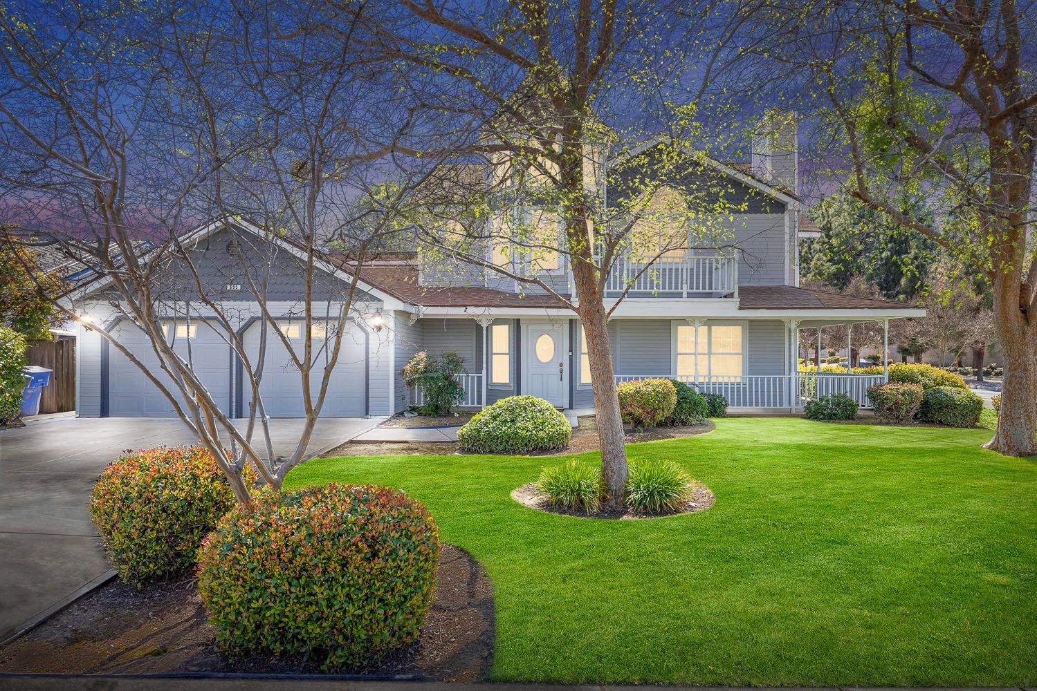 695 Monroe Street Coalinga, CA 93210 - Photo 2 of 44 a front view of a house with garden and trees
