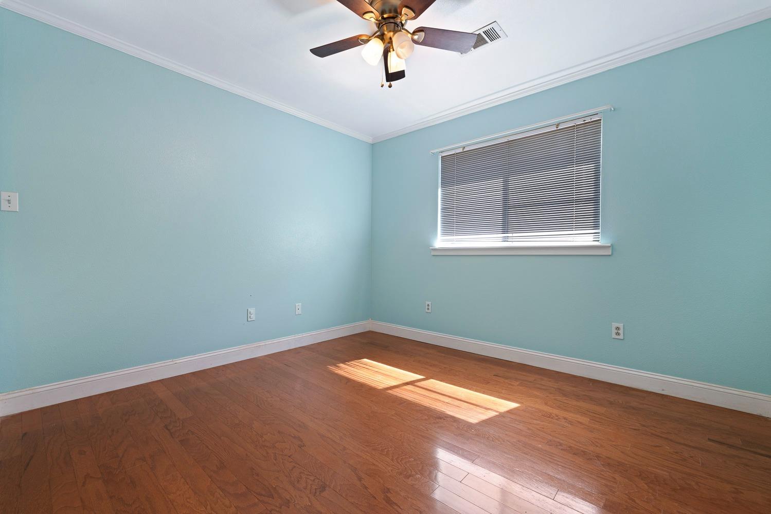 695 Monroe Street Coalinga, CA 93210 - Photo 24 of 44 an empty room with a window and ceiling fan