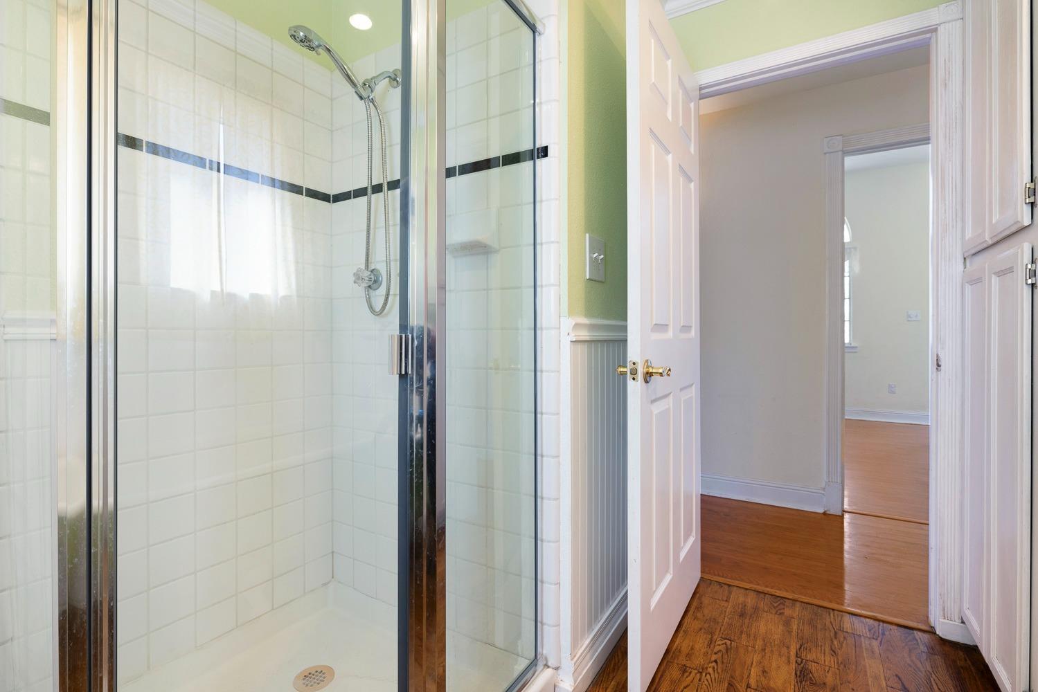 695 Monroe Street Coalinga, CA 93210 - Photo 27 of 44 a bathroom with a glass shower door and a mirror