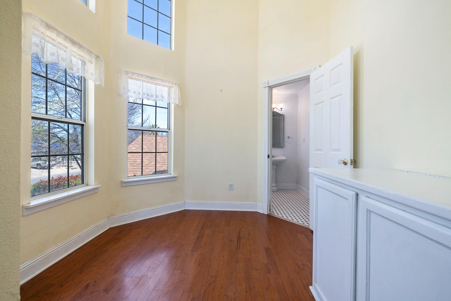 695 Monroe Street Coalinga, CA 93210 - Photo 36 of 44 an empty room with wooden floor and windows