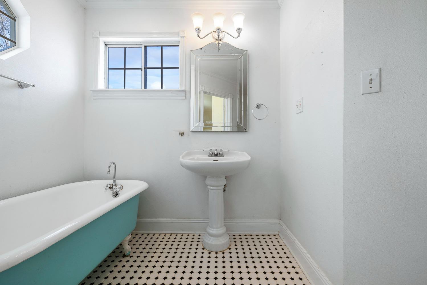 695 Monroe Street Coalinga, CA 93210 - Photo 37 of 44 a bathroom with a sink a mirror and a bathtub