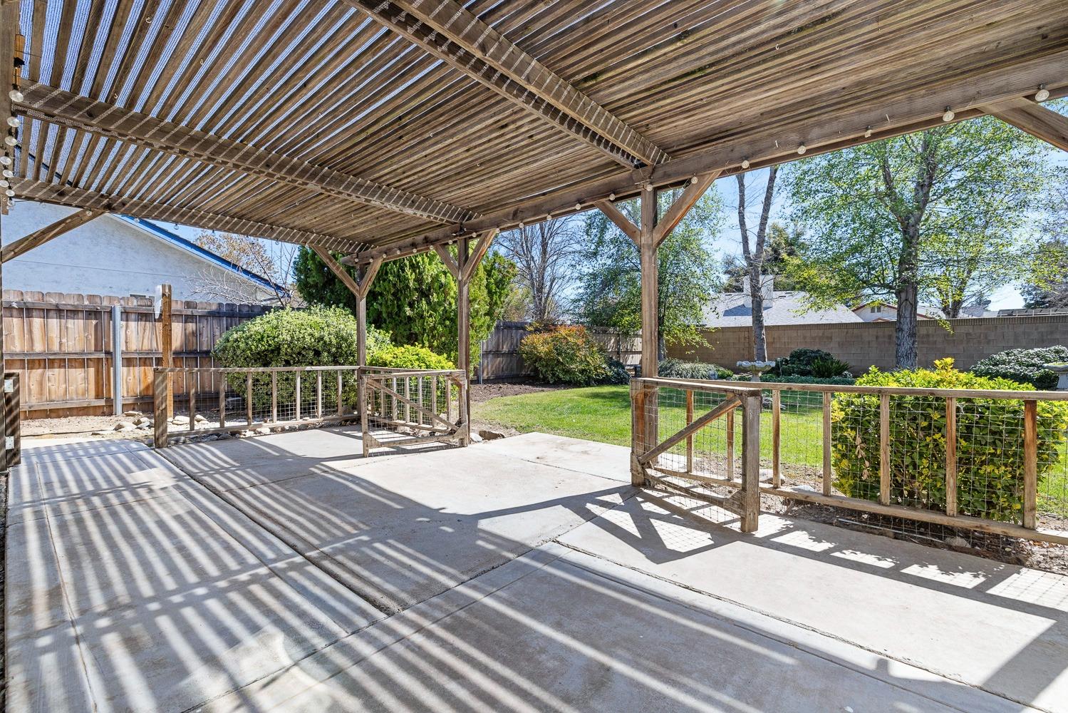 695 Monroe Street Coalinga, CA 93210 - Photo 41 of 44 a view of a deck with wooden floor and roof with a garden view