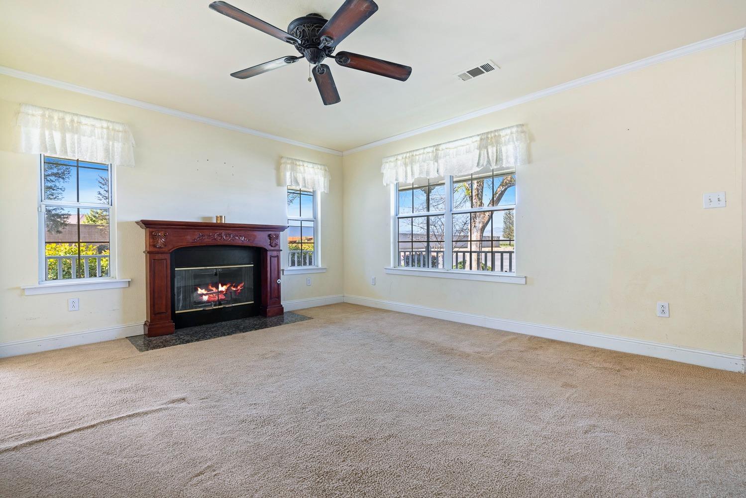 695 Monroe Street Coalinga, CA 93210 - Photo 7 of 44 a view of an empty room with window and fireplace