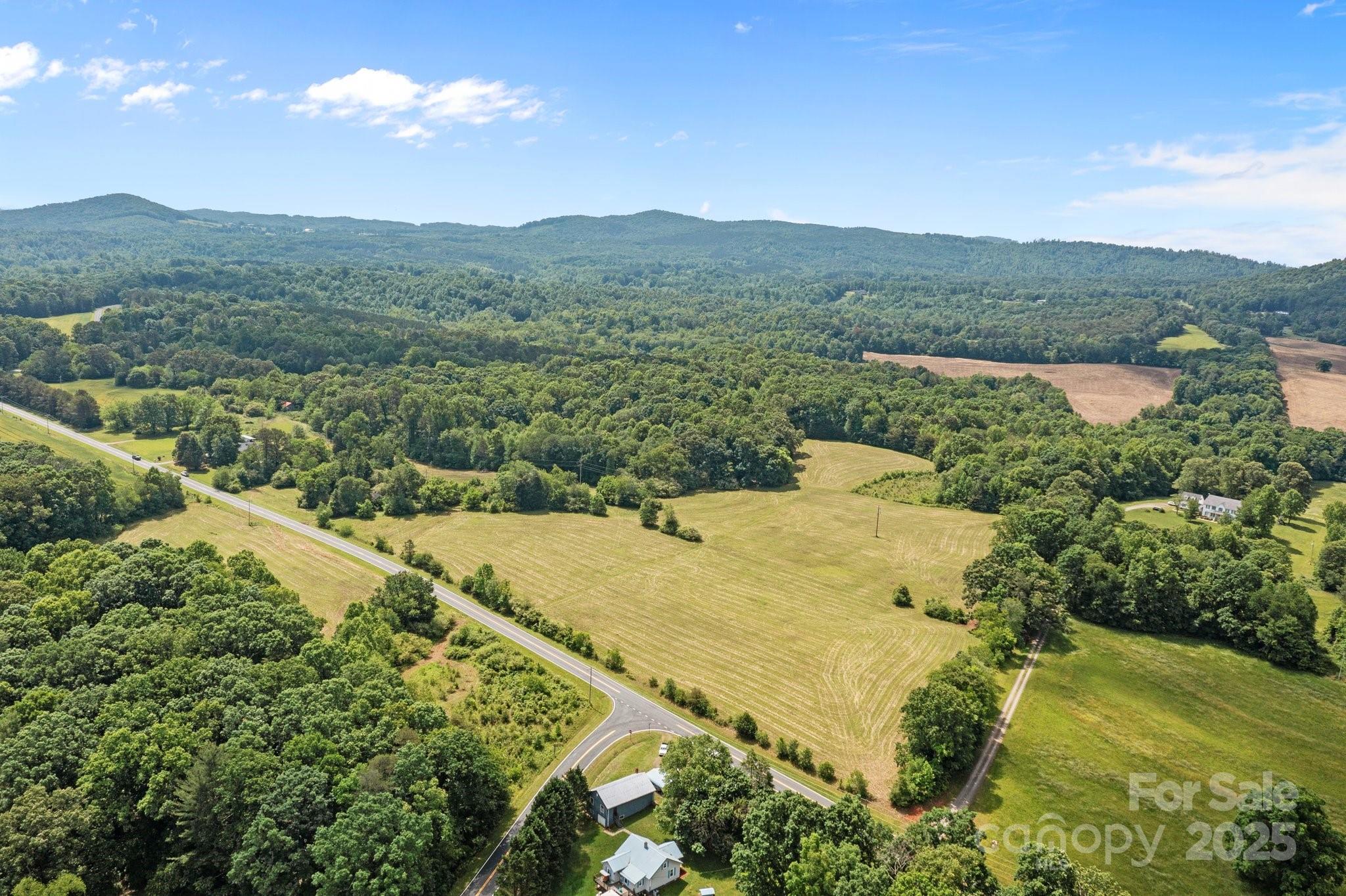 437 Linneys Mill Road Union Grove, NC 28689 - Photo 12 of 16 a view of a lake with a mountain in the background