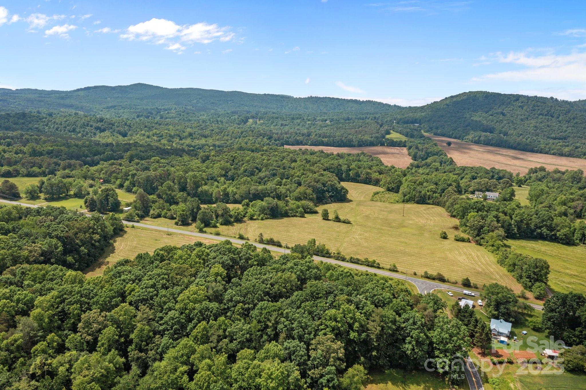437 Linneys Mill Road Union Grove, NC 28689 - Photo 3 of 16 a view of a lush green hillside and houses