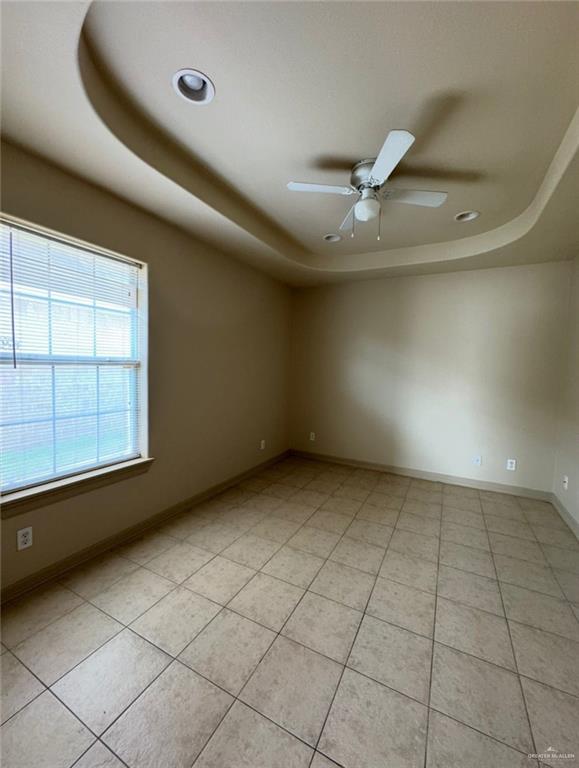 3603 Sheraton Avenue Pharr, TX 78577 - Photo 5 of 9 an empty room with windows and ceiling fan