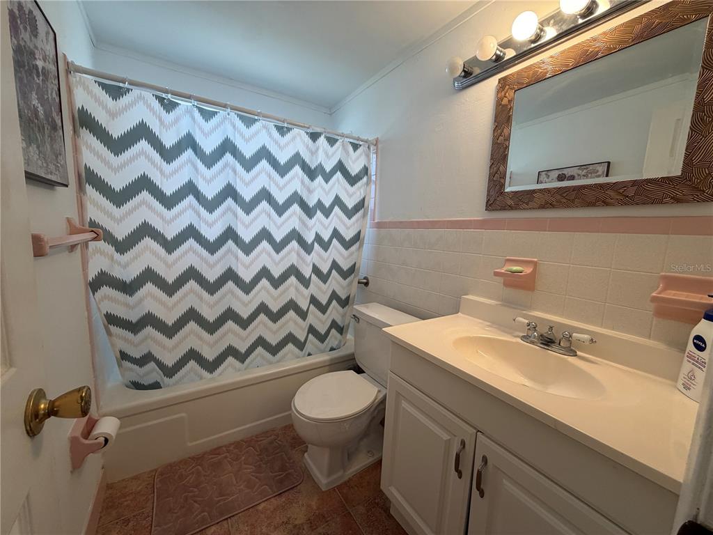 3914 Carioca Road Holiday, FL 34691 - Photo 19 of 23 a bathroom with a sink mirror vanity and toilet