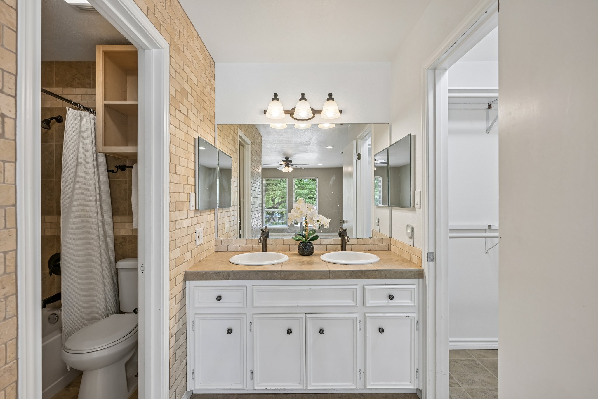 13101 Travis View Loop Austin, TX 78732 - Photo 15 of 27 Double vanities with warm tile accents define this well-appointed bath.