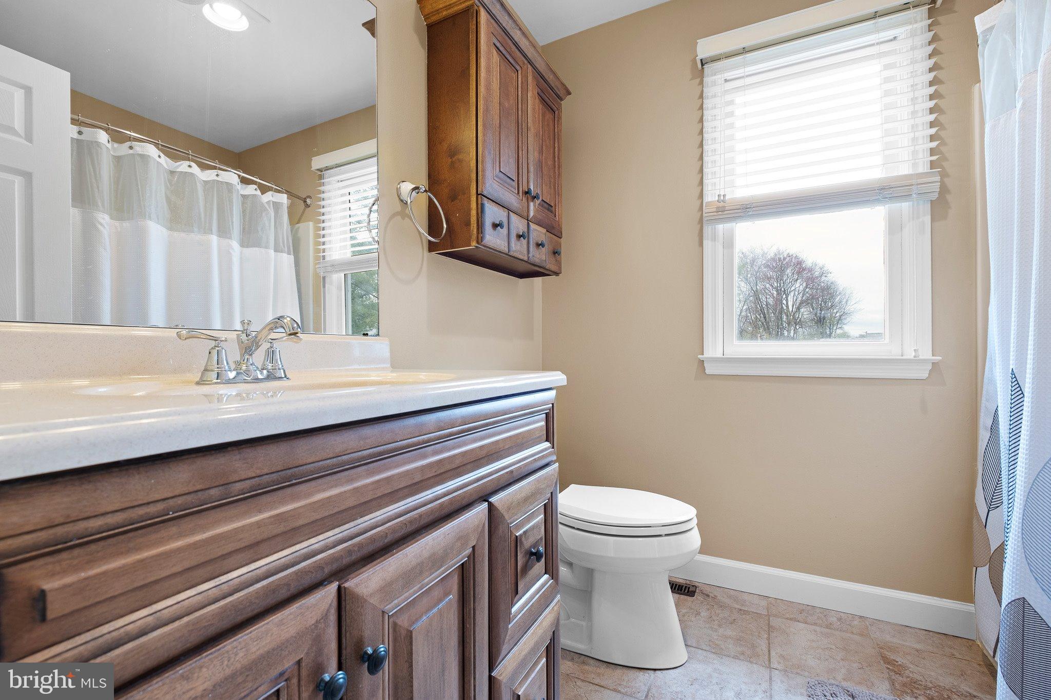 34 Sentry Lane Newark, DE 19711 - Photo 12 of 38 a bathroom with a sink a toilet and a mirror