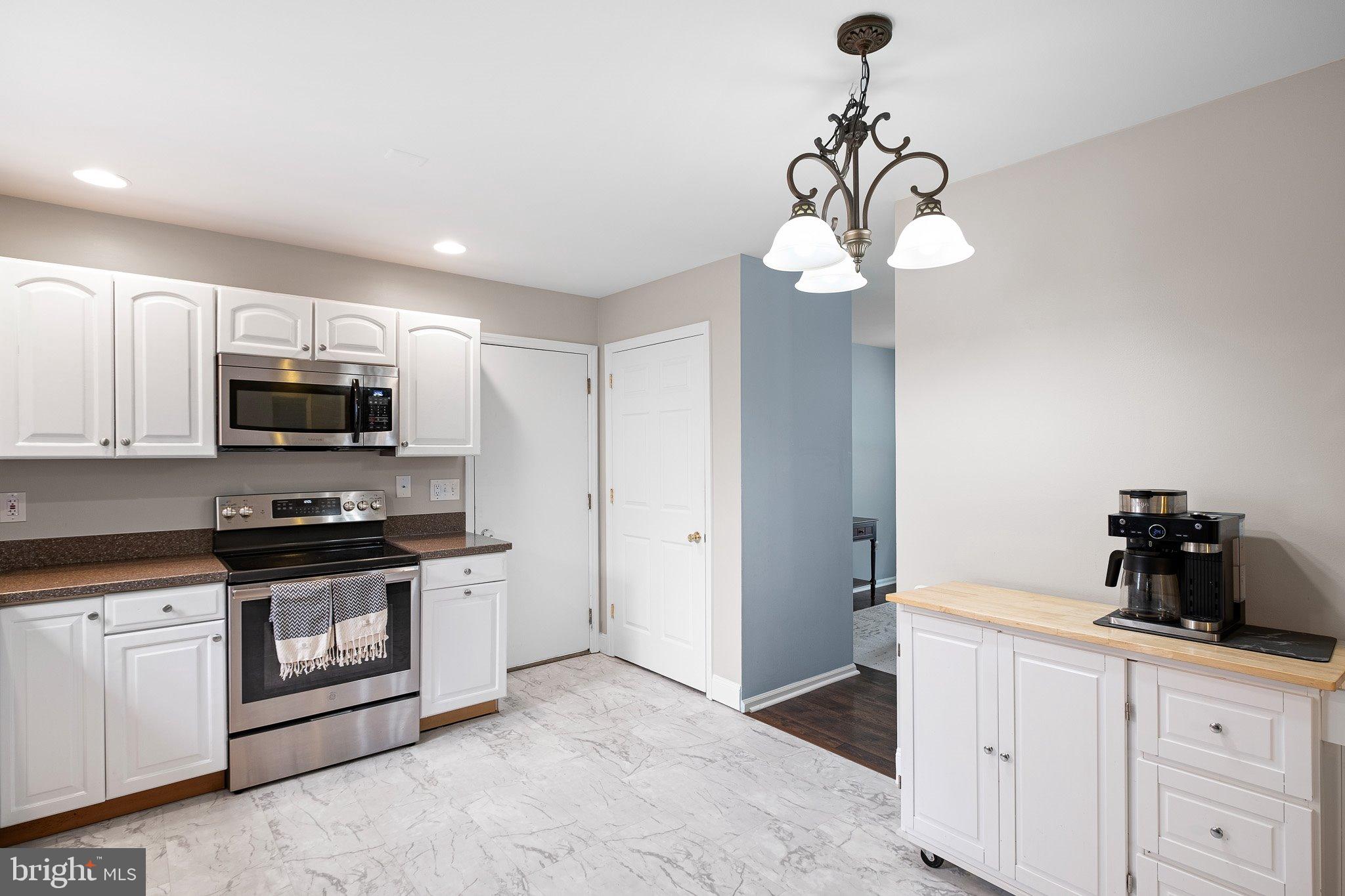 34 Sentry Lane Newark, DE 19711 - Photo 15 of 38 a kitchen with stainless steel appliances granite countertop white cabinets a stove a sink and dishwasher
