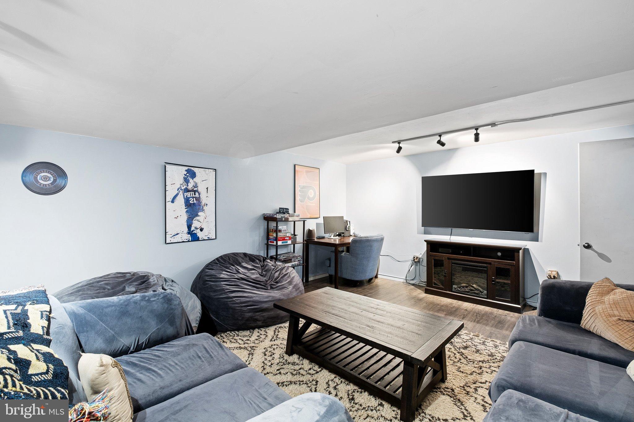 34 Sentry Lane Newark, DE 19711 - Photo 18 of 38 a living room with furniture a flat screen tv and a fireplace