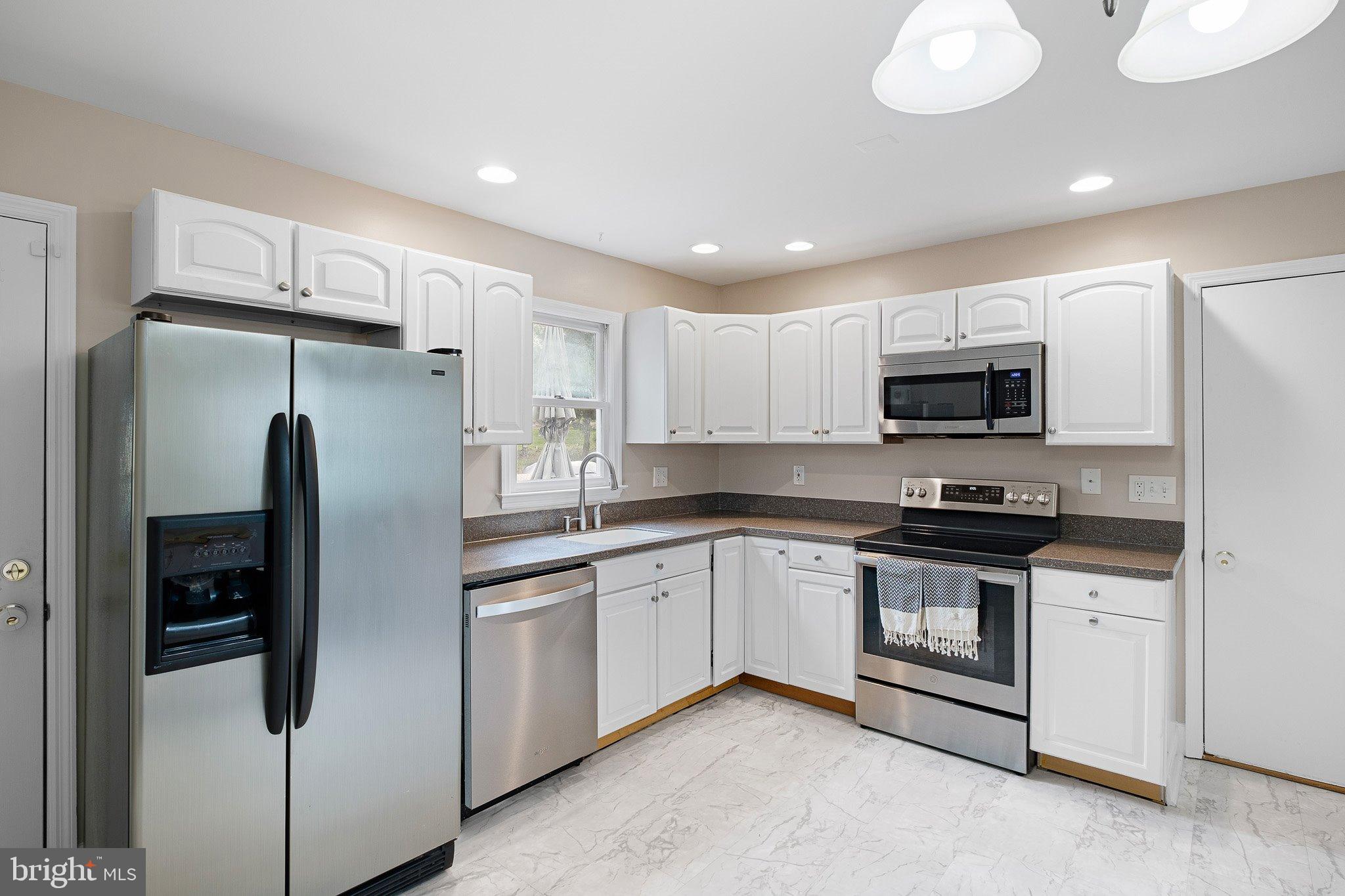 34 Sentry Lane Newark, DE 19711 - Photo 6 of 38 a kitchen with stainless steel appliances granite countertop a refrigerator sink and microwave
