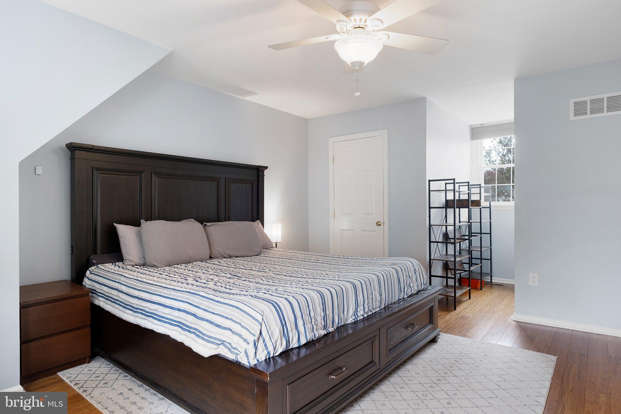 34 Sentry Lane Newark, DE 19711 - Photo 8 of 38 a bedroom with a bed and a chandelier