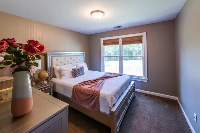 a living room with furniture and a view of kitchen