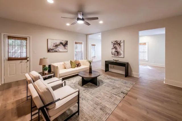 a view of a room with wooden floor and furniture