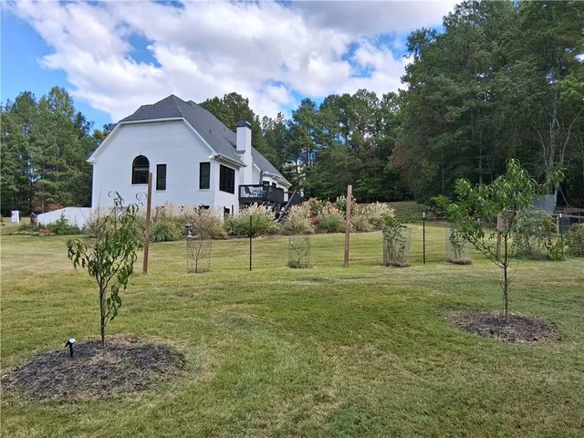 a view of outdoor space with deck and trees