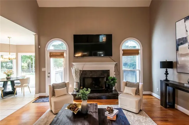 a living room with furniture fireplace and a flat screen tv