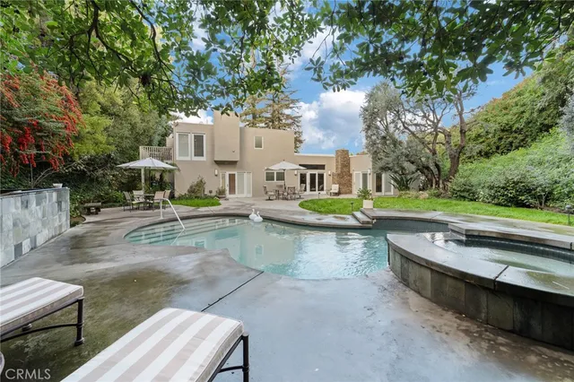 a view of swimming pool with outdoor seating and plants