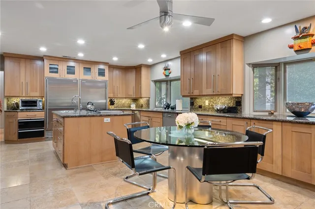 a kitchen with stainless steel appliances granite countertop a refrigerator and a stove
