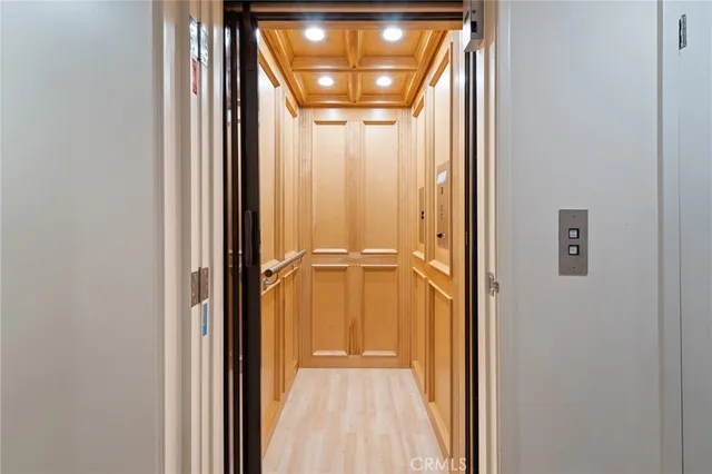 a spacious bedroom with a bed a couch and a large window