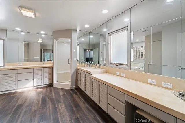 a view of a white house with a yard patio and a garden