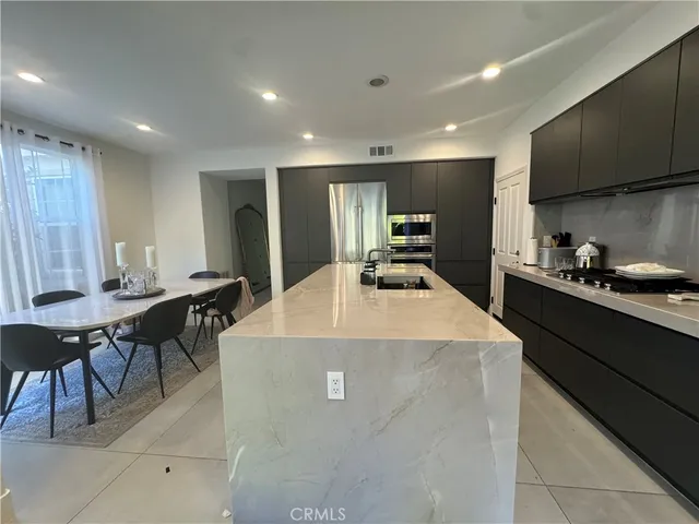 a large kitchen with kitchen island a island in the center