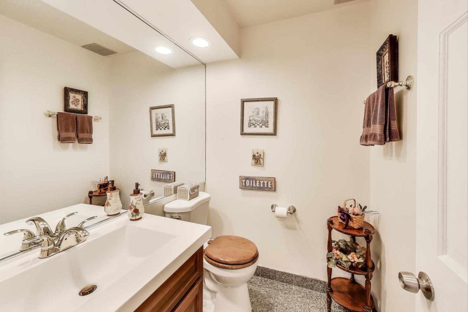 3955 Mission Hills Road, Unit D Northbrook, IL 60062 - Photo 16 of 26 a bathroom with a sink toilet and a mirror