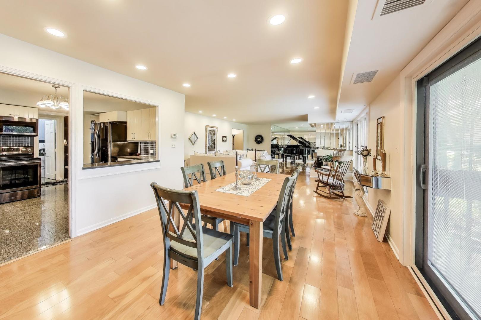 3955 Mission Hills Road, Unit D Northbrook, IL 60062 - Photo 9 of 26 a dining hall with stainless steel appliances a dining table chairs and couches