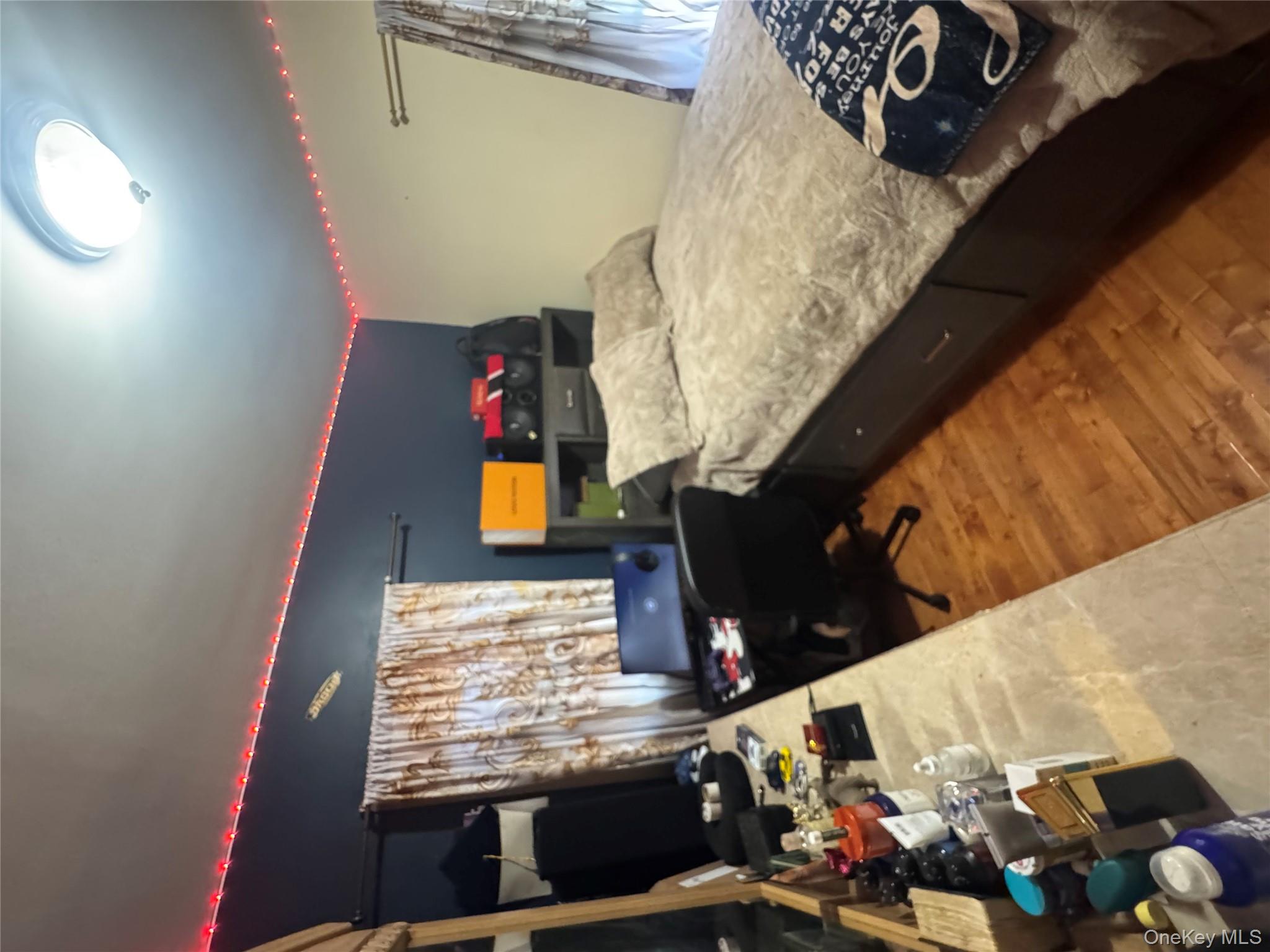 114-29 147th Street Queens, NY 11436 - Photo 11 of 12 a bedroom with a bed and a flat screen tv