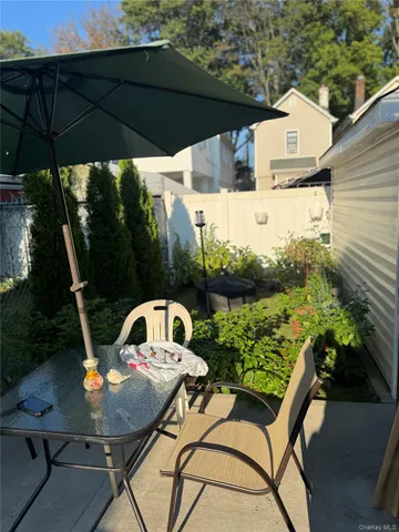 a view of a couches and dinning table in patio