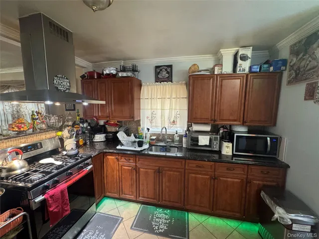 a kitchen with stainless steel appliances a stove a sink dishwasher and cabinets