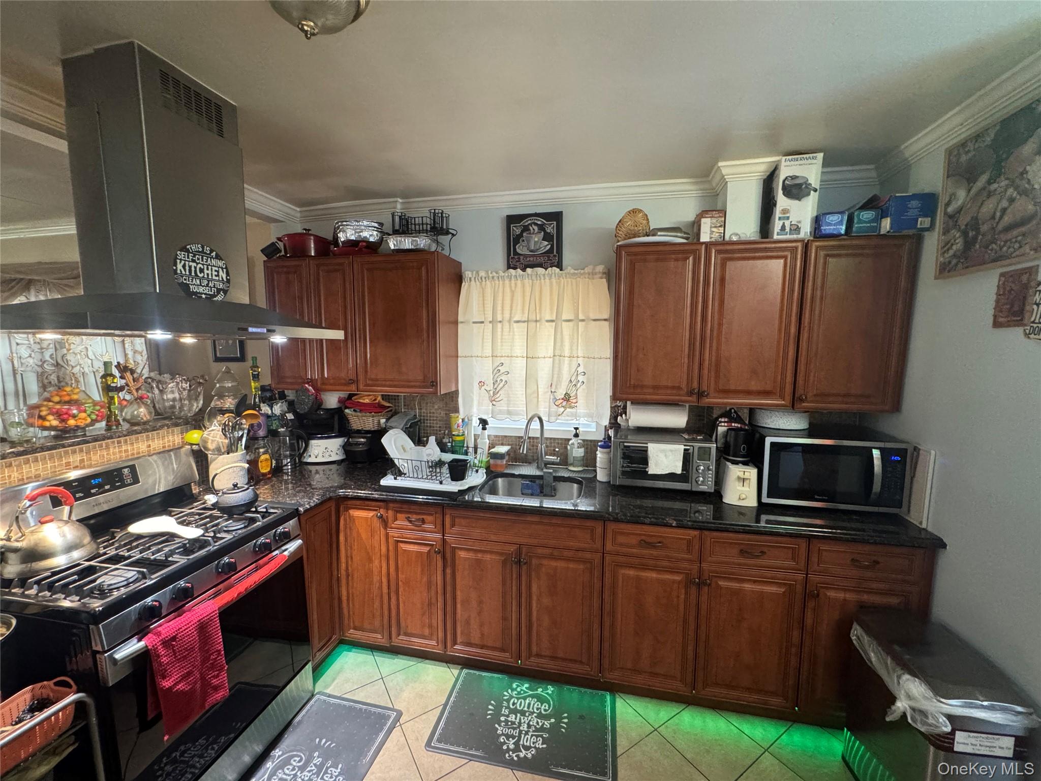 114-29 147th Street Queens, NY 11436 - Photo 6 of 12 a kitchen with stainless steel appliances a stove a sink dishwasher and cabinets