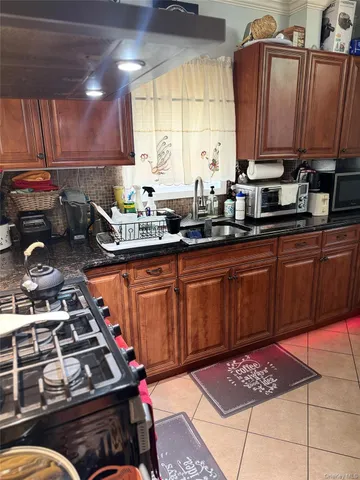 a kitchen with stainless steel appliances a stove a sink dishwasher and cabinets