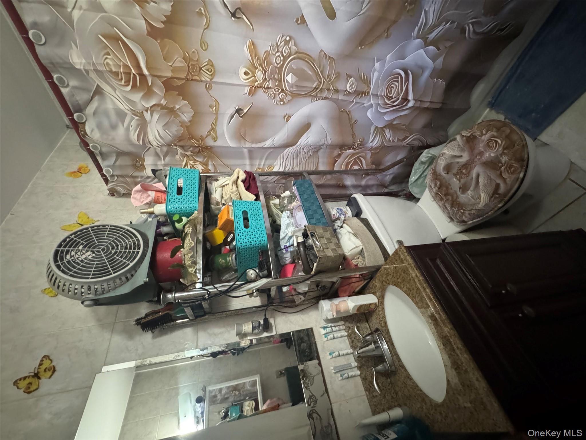 114-29 147th Street Queens, NY 11436 - Photo 10 of 12 a bathroom with a sink mirror vanity and toilet