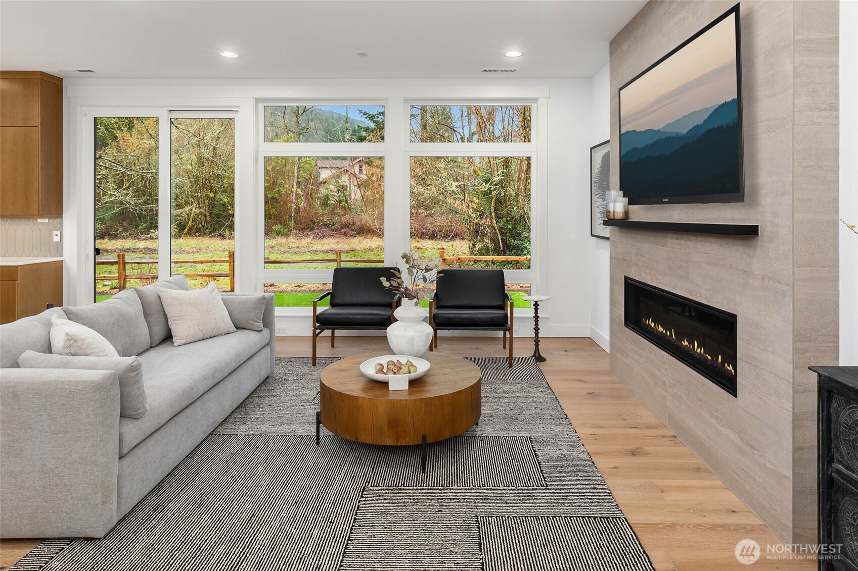 21021 Southeast 80th Street Issaquah, WA 98027 - Photo 11 of 38 a living room with furniture a flat screen tv and a fireplace