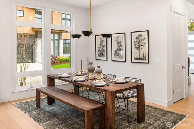 a living room with furniture kitchen view and a large window