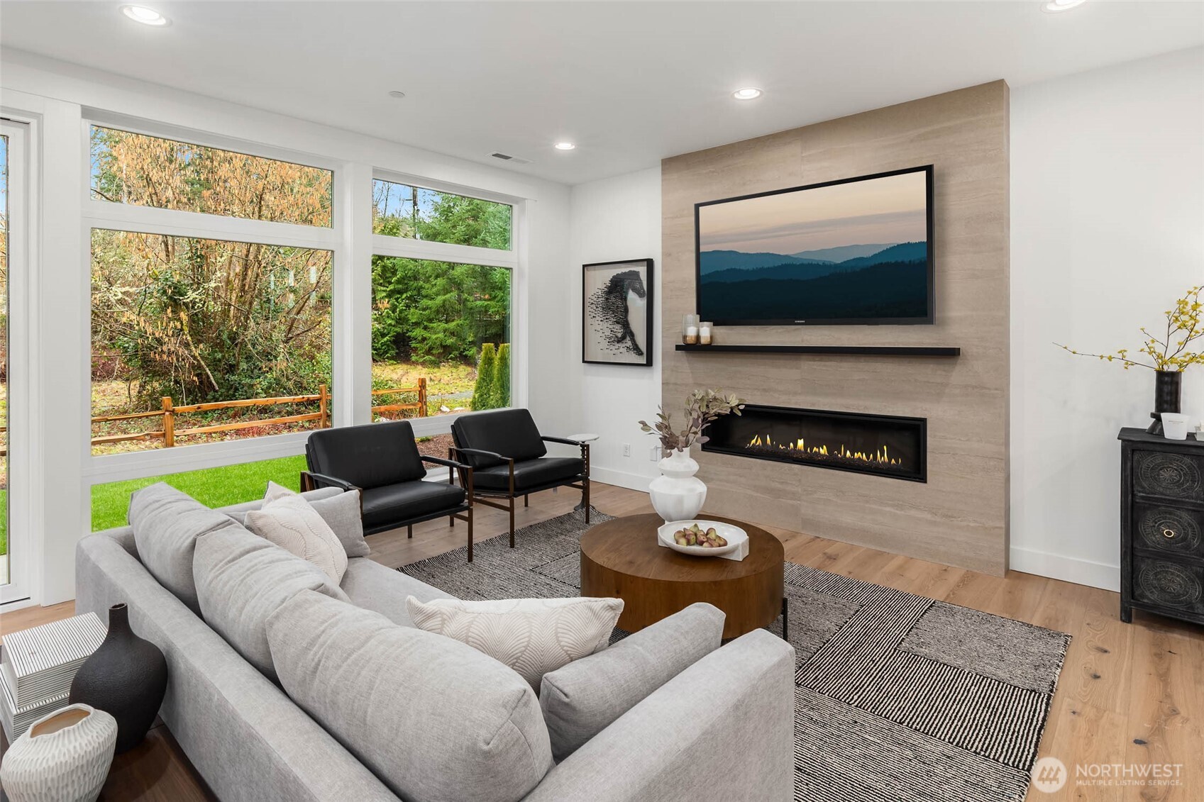 21021 Southeast 80th Street Issaquah, WA 98027 - Photo 12 of 38 a living room with furniture a flat screen tv and a fireplace