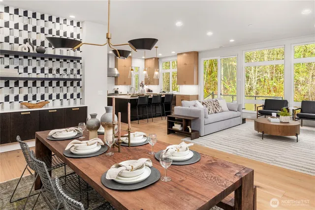 a kitchen with a sink a stove a refrigerator and chairs