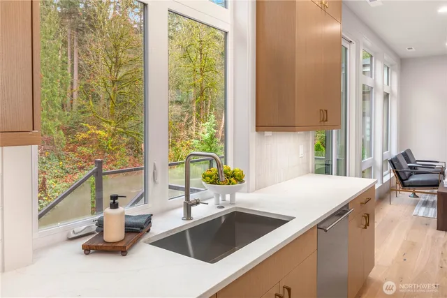 a kitchen with a sink stove top oven and cabinets