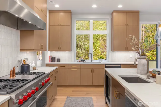 a kitchen with a table chairs stove and kitchen island