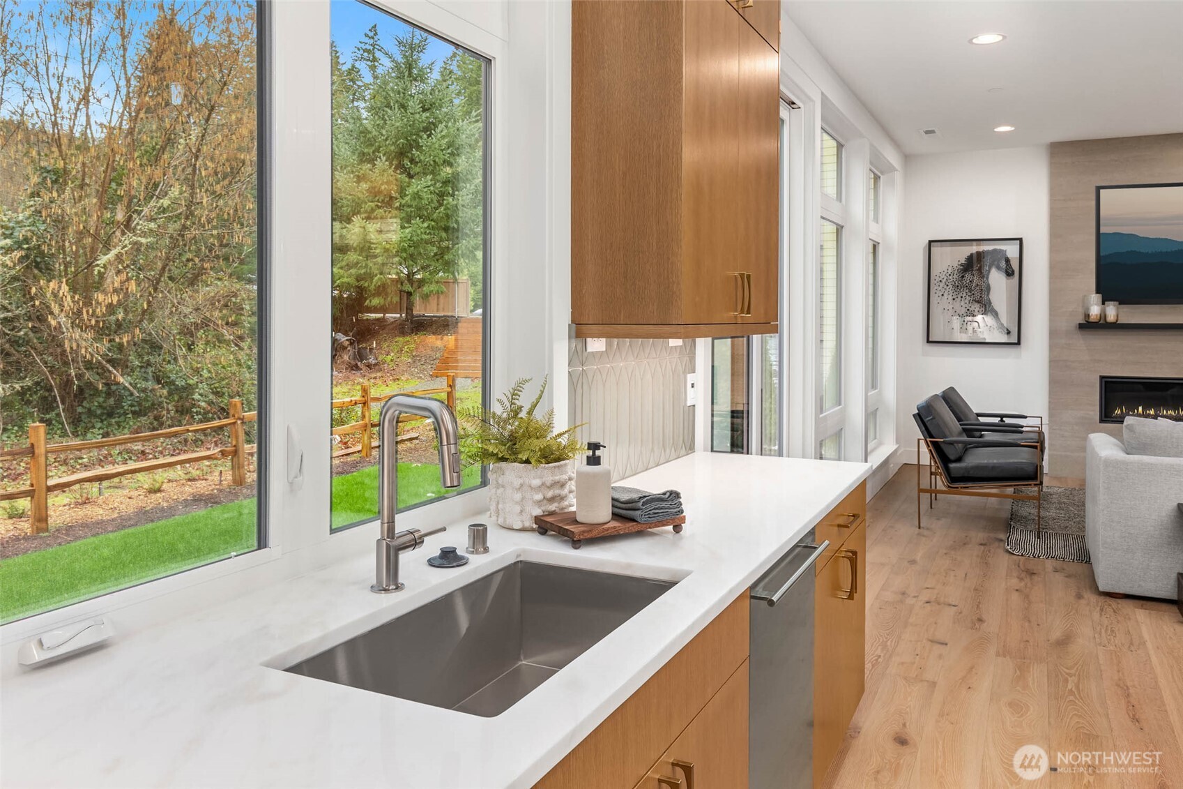 21021 Southeast 80th Street Issaquah, WA 98027 - Photo 21 of 38 a kitchen with a sink a counter top space and living room filled with furniture