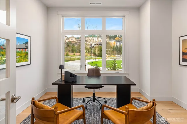 a living room with furniture a rug and a flat screen tv